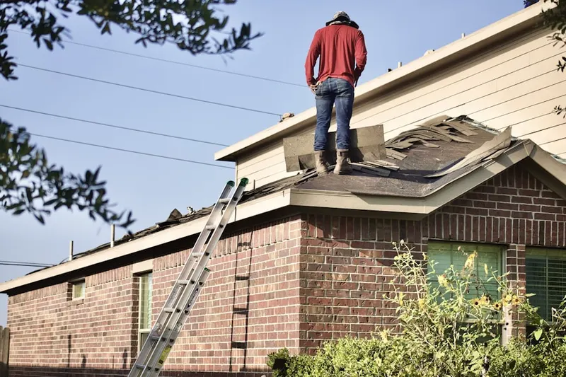 Professional roofer working on a residential roof in Kohler